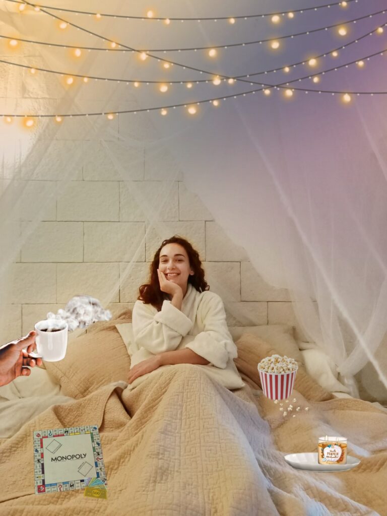girl in princess bed with monopoly game, scented candle, hand holding coffee and popcorn