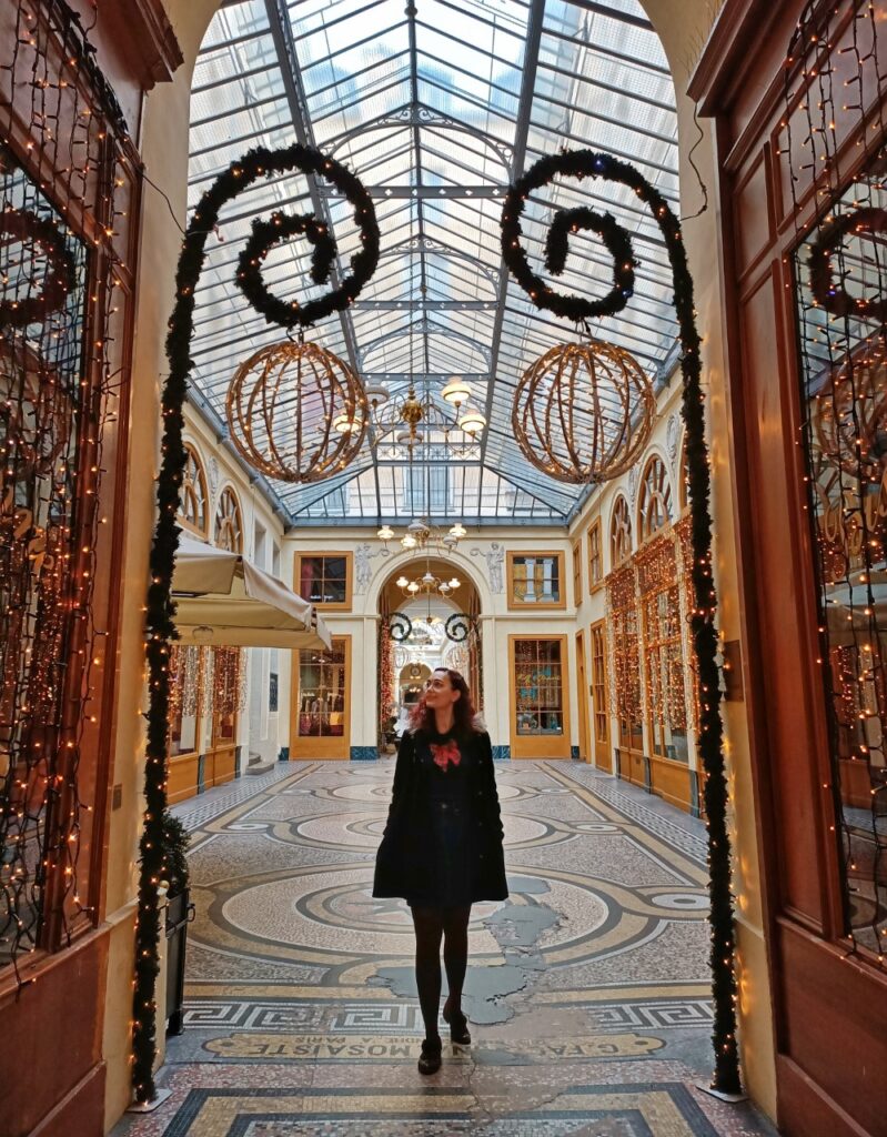 Entrance of the Galerie Vivienne in Paris with Christmas lights.