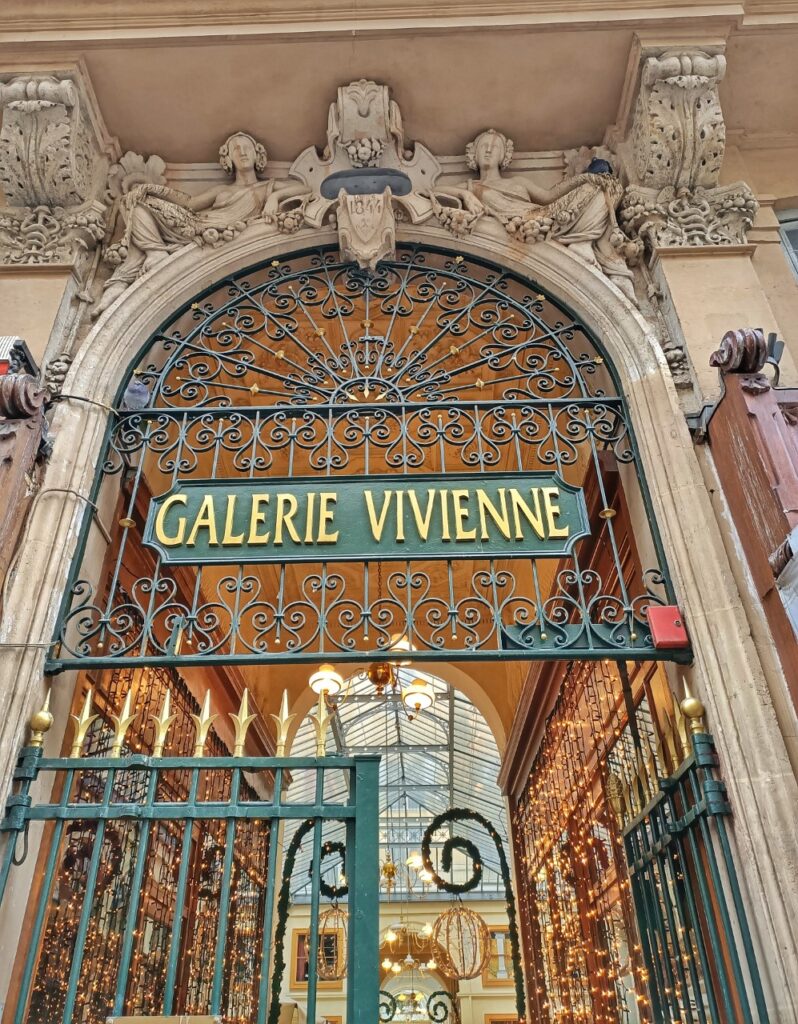 Entrance door of the Galerie Vivienne in Paris, with sparkling Christmas lights.