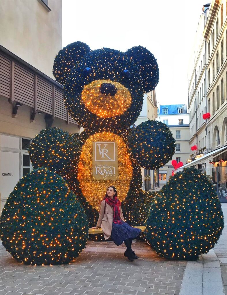 Village Royal In Paris, Christmas display in the shape of a big teddy bear with gold lights shining.