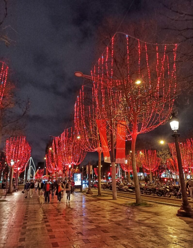 Champs Elysées in Paris with Christmas lights and trees.
