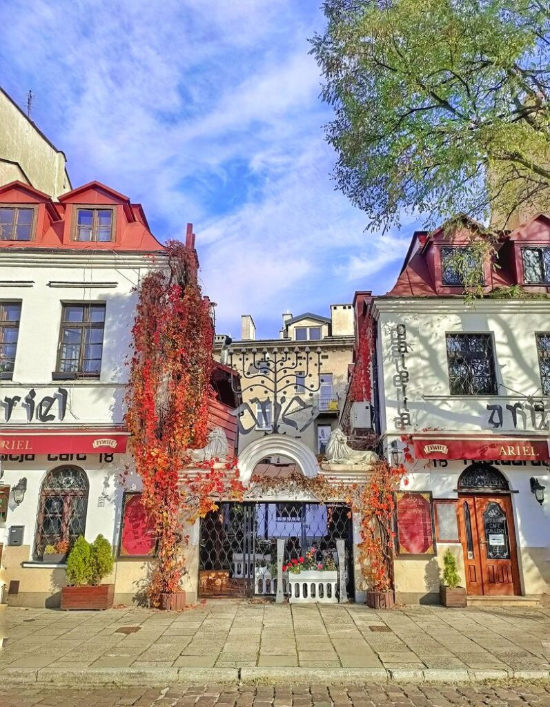A typical Jewish restaurant in Kazimierz, the Jewish Quarter of Krakow, Poland. The facade of the restaurant in covered in red autumn leaves.