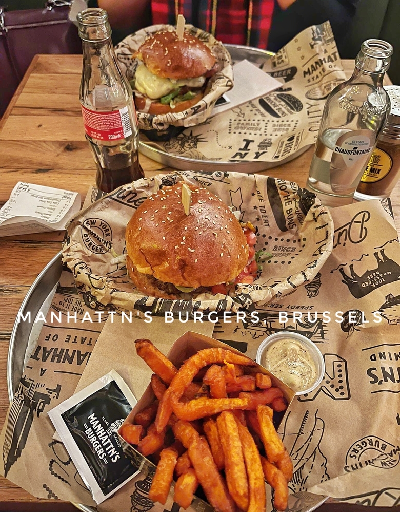 Burgers and fries from Manhattn's Burgers in Brussels, Belgium. There are sweet potato fries and two delicious burgers.
