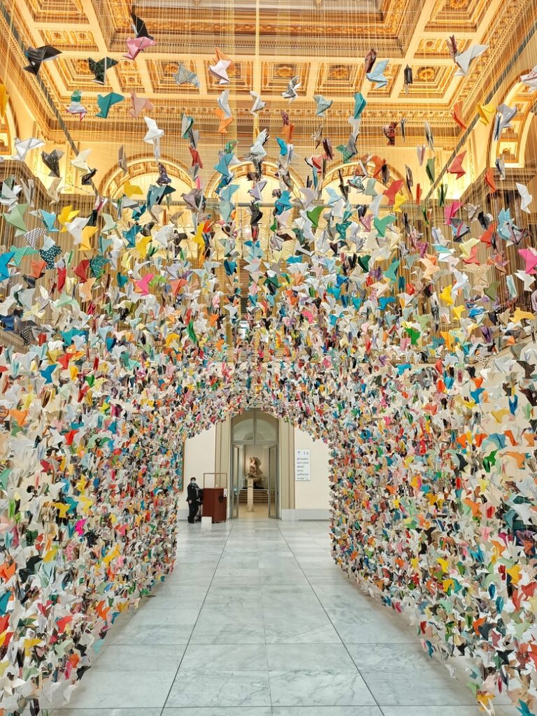 Big origami display at the Brussels Fine Arts museum. The display is made of hundreds of origami birds of all colours and patterns, made by inhabitants of Brussels during the 2020 lockdown.