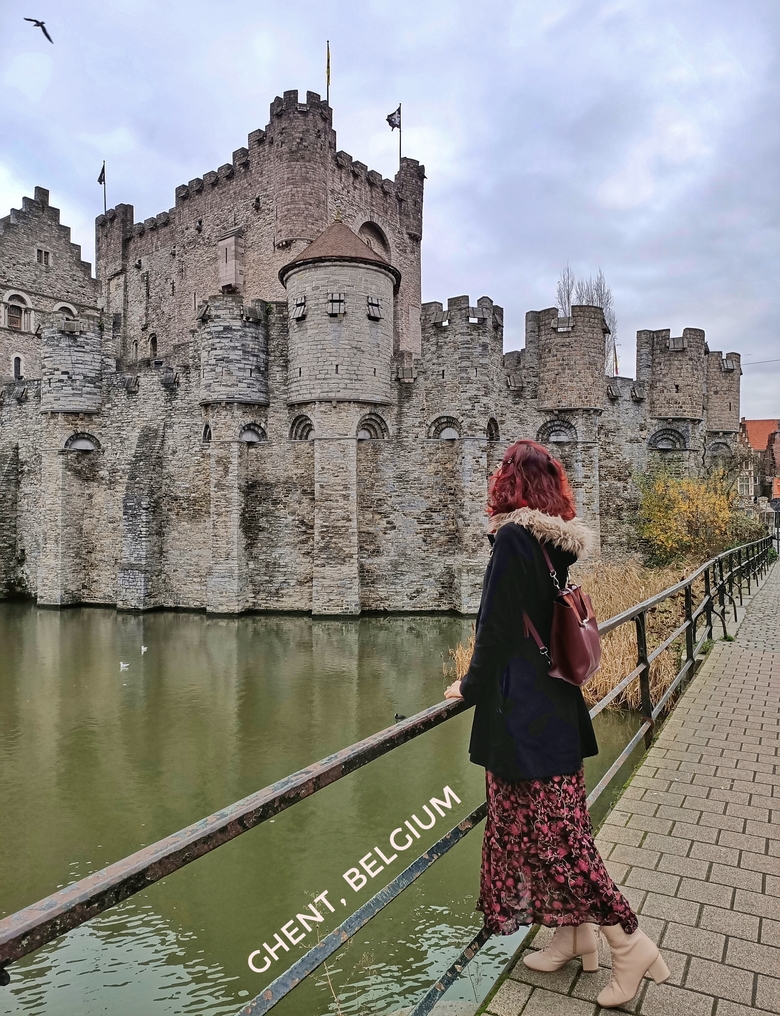 I am standing in front of Gravensteen Castle in Ghent, Belgium. The canal is running to the side of the castle.